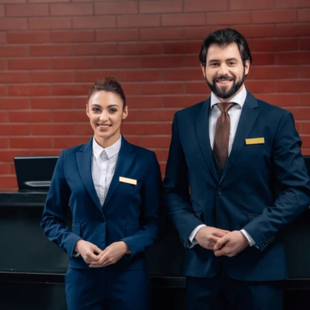 hotel receptionists standing together front 600nw 1044828835